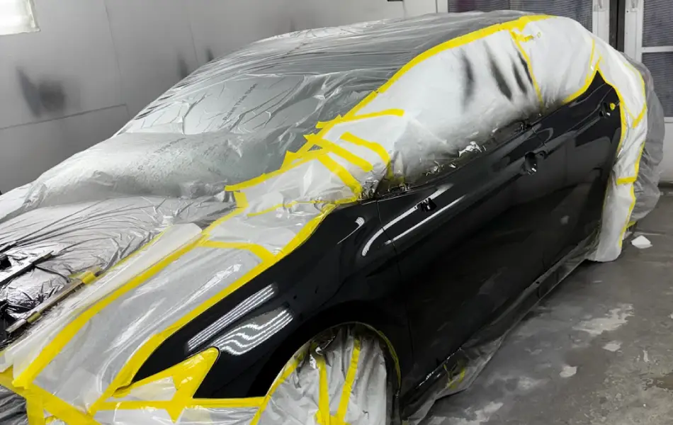 Vehicle masked for paint refinishing at Franklin Auto Body Shop.