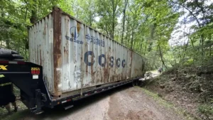 Rusty Shipping Container Transported on Gooseneck Trailer