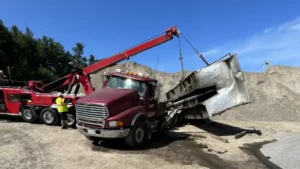 Heavy Wrecker Recovering Overturned Dump Truck