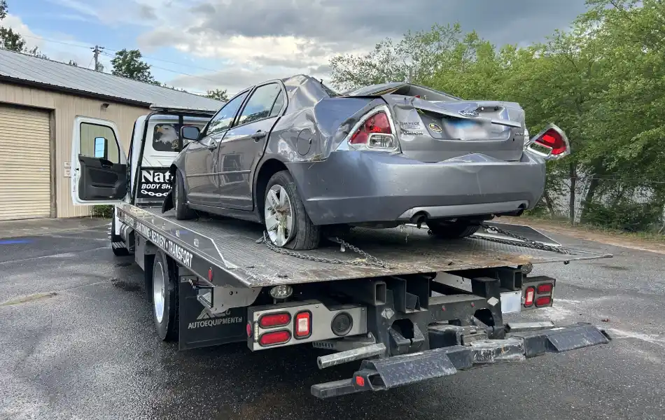 Towing in Sylva NC wrecked car on rollback by Nathan’s Body Shop & Wrecker Service, serving Sylva, Jackson County NC, and surrounding areas.