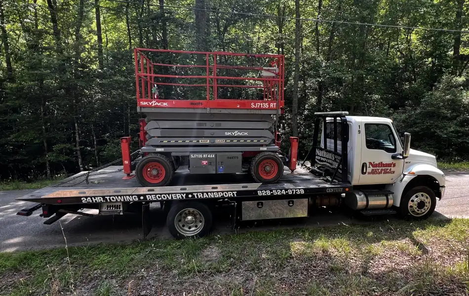 Flatbed Towing construction equipment by Nathan’s Body Shop & Wrecker Service in Franklin NC
